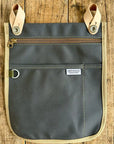 Gray organizer bag with beige accents on a wooden surface
