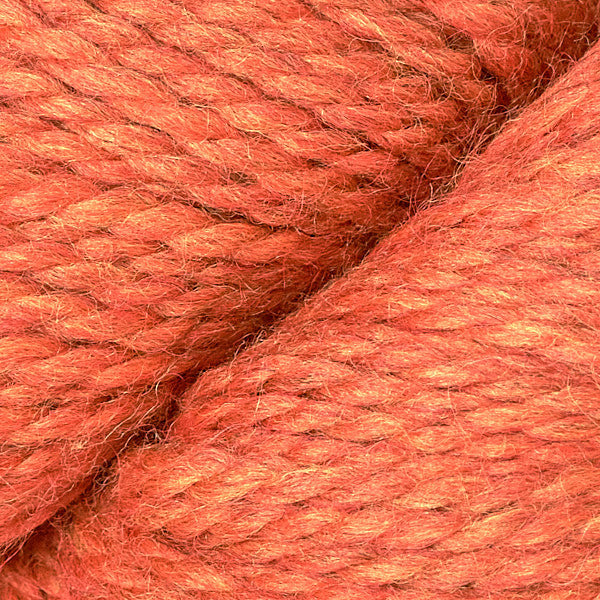 Close-up of pinkish orange yarn with visible texture