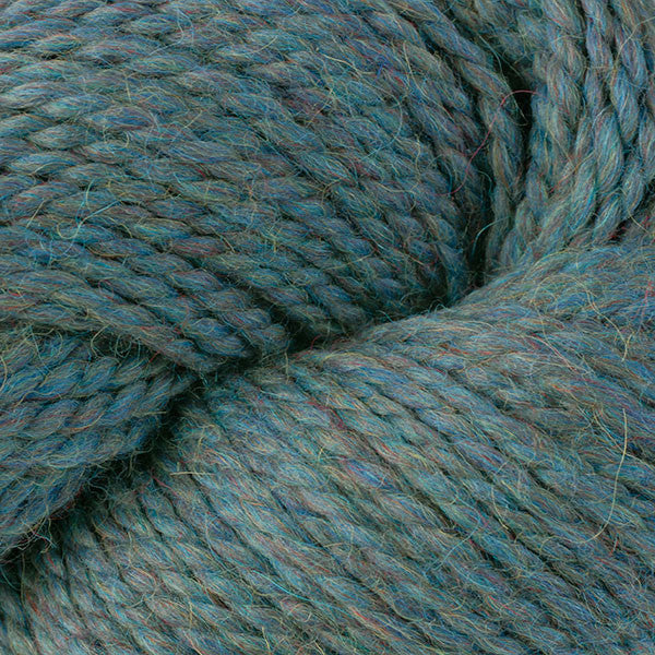 Close-up of a skein of middle tone teal  with tan heathers yarn