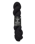 Black skein of yarn with Laine Novita label on a white background