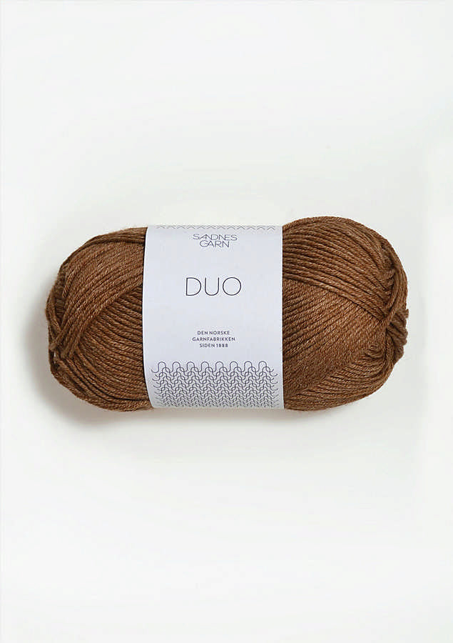 Brown skein of yarn with a label on a white background