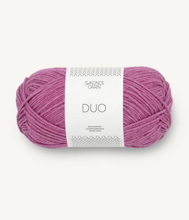 Ball of pink yarn with a label on a white background