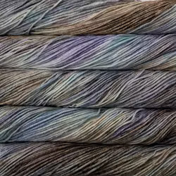 Close-up of multicolored yarn skeins with light blues, beige, lavender and grey.