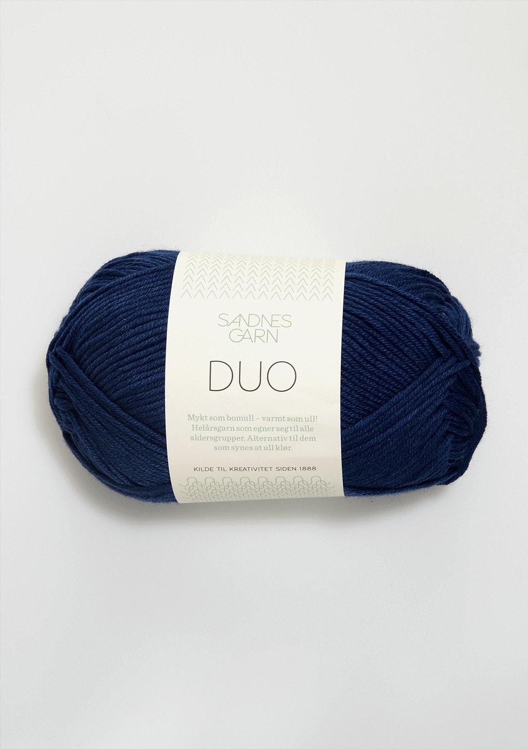 Navy blue skein of yarn with a label on a white background