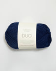 Navy blue skein of yarn with a label on a white background