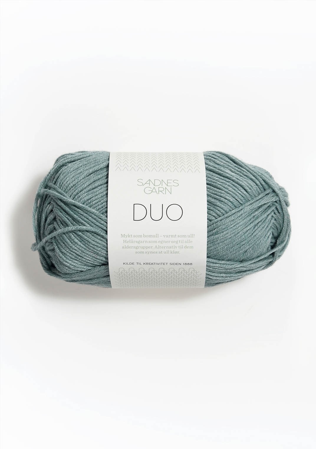 Ball of sage blue yarn with a label on a white background