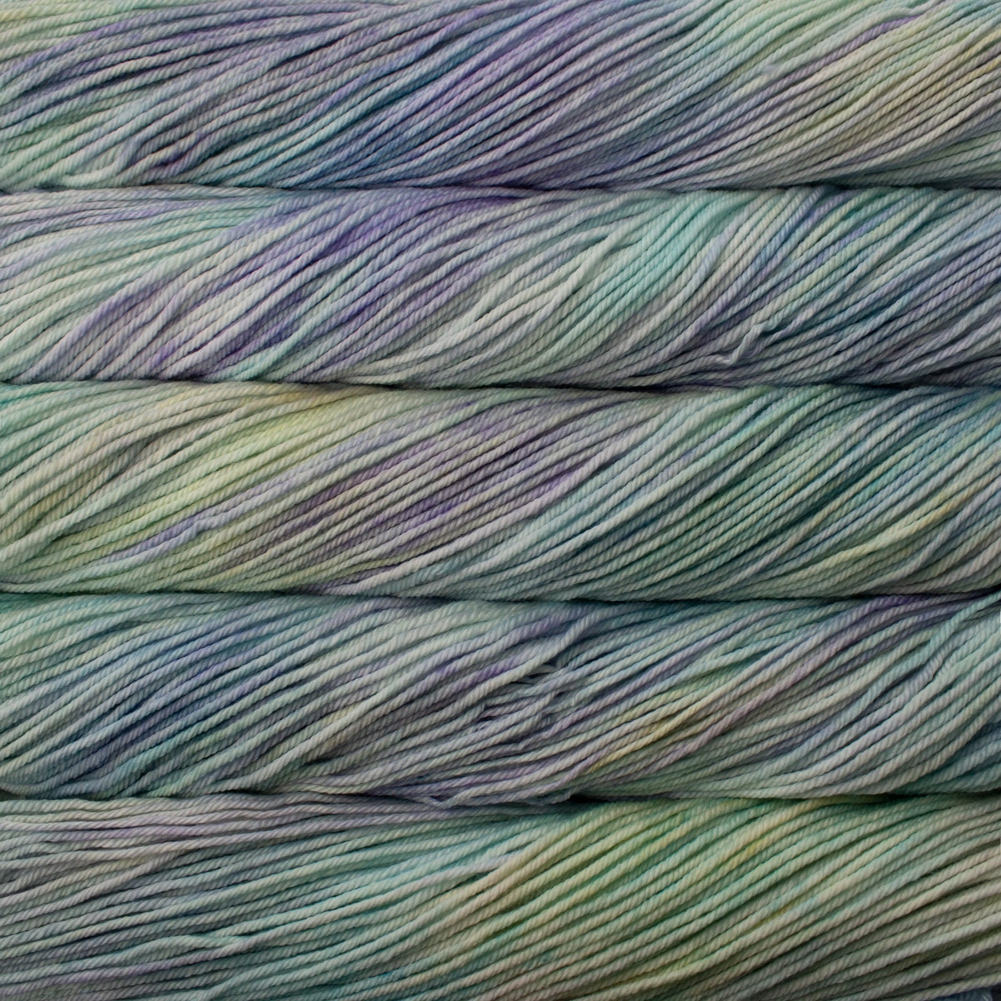 Close-up of multicolored yarn skeins with a gradient of pale colors including blue, green, and purple.