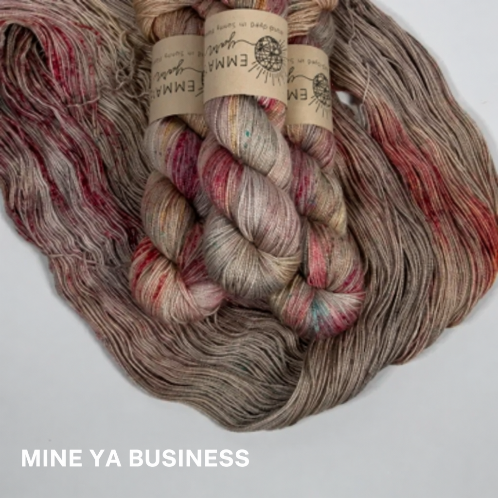 Three skeins of taupe with deep red multicolored yarn with labels on a white background